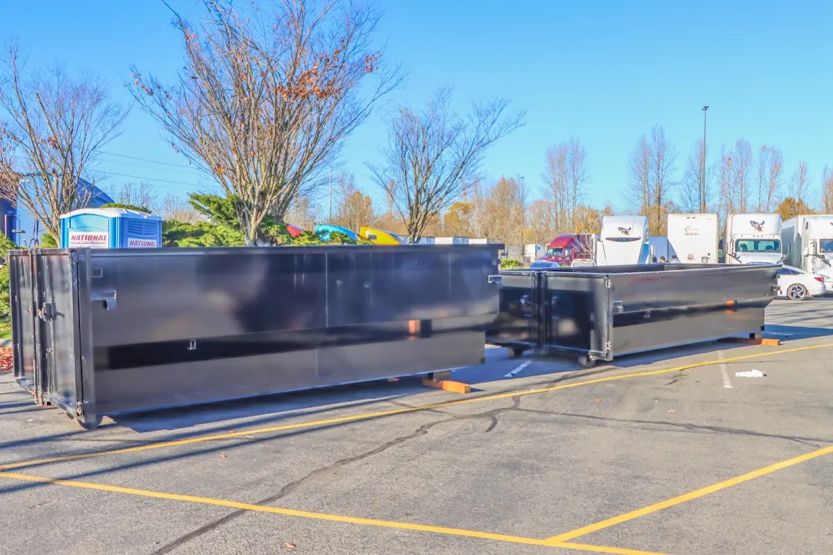 Professional dumpster rental service with roll-off container on residential driveway in Chanute